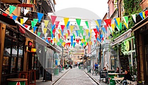 Colorful flags in a street in a Greek town