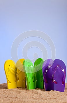 Colorful Flip-Flop Sandles on a Sandy Beach