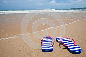 Colorful flipflop footware on sea beach