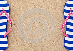 Colorful flipflop pair on beach sand