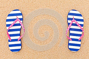 Colorful flipflop pair on beach sand