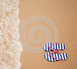 Colorful flipflop pair on sea beach