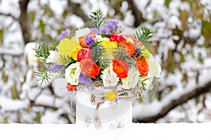 Colorful floral arrangement in the snow photo