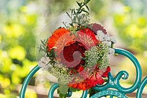 Colorful flower bouquet with dalias on a romantic garden chair photo
