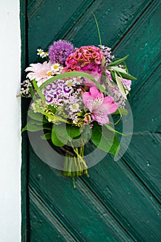 Colorful flower bouquet on a wooden door