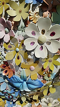 Colorful flower elements of sculpture suface with high contrast of daylight shadow cast