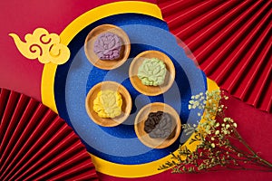 Colorful flower shape snowy mooncakes with Chinese decorations