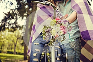 Colorful flowers bouquet on bicycle handlebar.