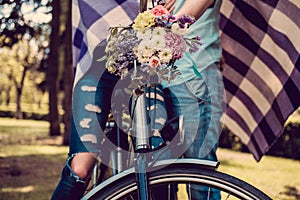 Colorful flowers bouquet on bicycle handlebar.