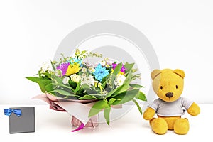 Colorful flowers bouquet composition.Beautiful tenderness flowers,teddy bear,gift box.Spring floral romantic mockup