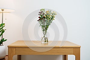 Colorful flowers bouquet in mason jar on table background. Happy day with fresh flower