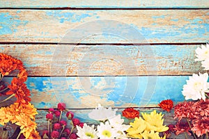 Colorful flowers bouquet on vintage wooden background,