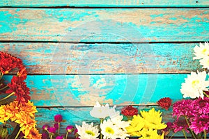 Colorful flowers bouquet on vintage wooden background