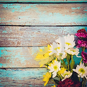 Colorful flowers bouquet on vintage wooden background,