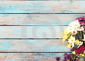 Colorful flowers bouquet on vintage wooden background,