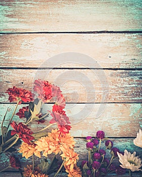 Colorful flowers bouquet on vintage wooden background,