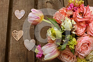 Colorful flowers bouquet on wooden table. Top view