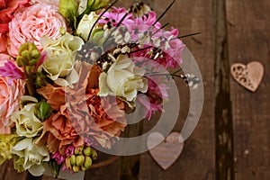 Colorful flowers bouquet on wooden table. Top view