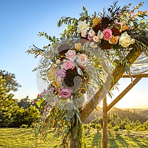 Colorful flowers and lace cloth on a wooden Huppah