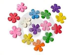 Colorful flowers plasticine, multicolored clay, heart shaped dough, white background