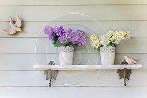 Colorful flowers in pots vintage on wall