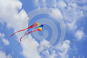 Colorful flying kite flying in sky with clouds