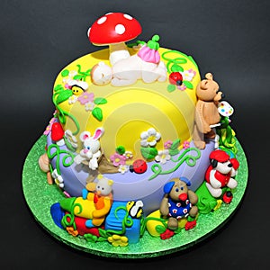 Colorful fondant cake with animals figurines