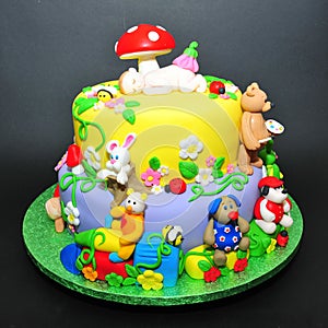 Colorful fondant cake with animals figurines