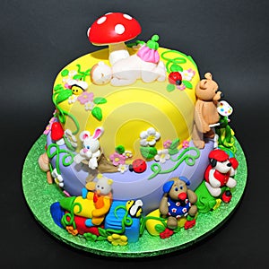 Colorful fondant cake with animals figurines photo
