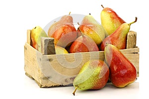 colorful Forelle pears in a wooden crate