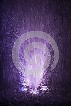 Colorful fountain splashes light violet and white color