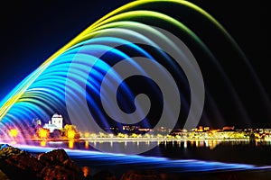 Colorful fountains in city park at night time, long exposure photo