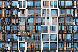 A colorful fragment of the facade of a multi-storey building under construction, its insulation with mineral insulation using a