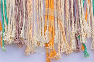 Colorful frayed macrame threads texture for background. Close up