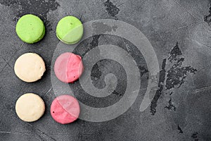 Colorful french macarons, on gray stone table background, top view flat lay, with copy space for text