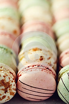 Colorful french macaroons flat lay. Pastel colors pink, green, yellow macarons with copy space, top view. Holidays and