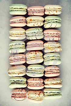 Colorful french macaroons flat lay. Pastel colors pink, green, yellow macarons with copy space, top view. Holidays and