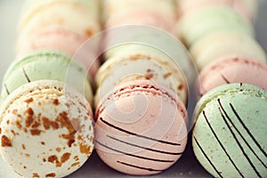 Colorful french macaroons flat lay. Pastel colors pink, green, yellow macarons with copy space, top view. Holidays and