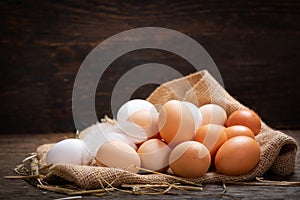 Colorful fresh eggs on a wooden table