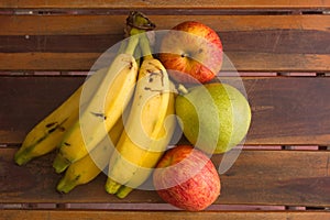 Colorful fresh summer fruits on brown wooden background, healthy organic food on table, detox vitamin nutrition for health care.