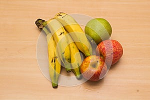 Colorful fresh summer fruits on yellow wooden background, healthy organic food on table, detox vitamin nutrition for health care.