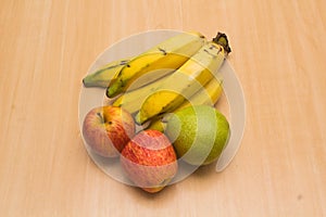 Colorful fresh summer fruits on yellow wooden background, healthy organic food on table, detox vitamin nutrition for health care.