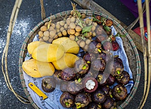 Colorful fresh tropical fruits in the basket for sale at Vietnam local street