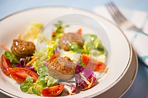 Colorful fresh vegetable salad with meatballs