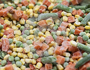 Colorful frosted vegetables carrot, corn and peas