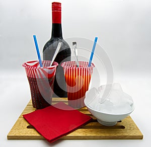 Colorful frozen drinks, bottle, ice cubes, red paper towels, white background