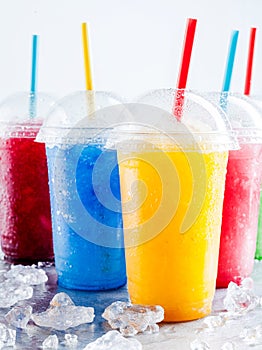 Colorful Frozen Fruit Slush Drinks in Plastic Cups