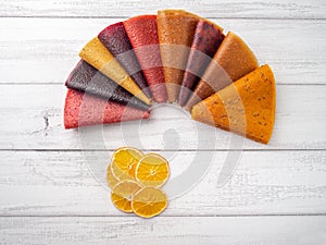 Colorful fruit leather rolls on light background