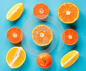 Colorful fruit pattern of fresh citruses on a blue background. Concept orange and lemon.