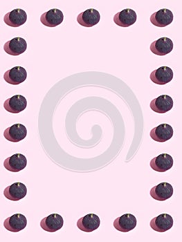 Colorful fruit pattern of fresh figs on purple pastel background, top view, flat lay